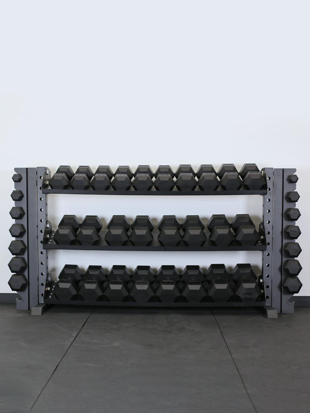Force USA rubber hex dumbbells on a rack
