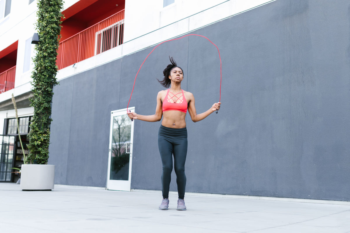 Woman skipping with a speed rope outdoors