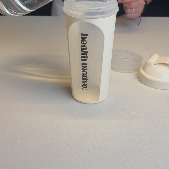 Health Motive Weight Loss Shake Indulgent Chocolate being mixed in a shaker and poured into a glass