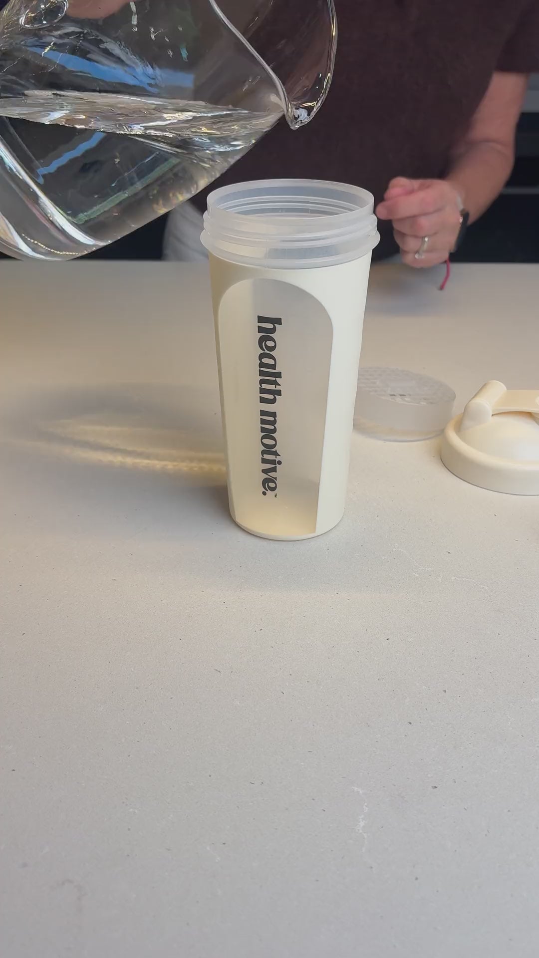 Health Motive Weight Loss Shake Indulgent Chocolate being mixed in a shaker and poured into a glass